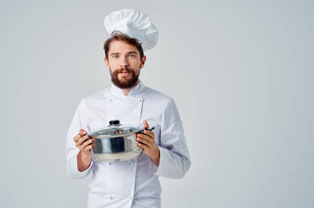 istock Cheerful male chef with a saucepan in his hands providing service work in a restaurant 2117150281
