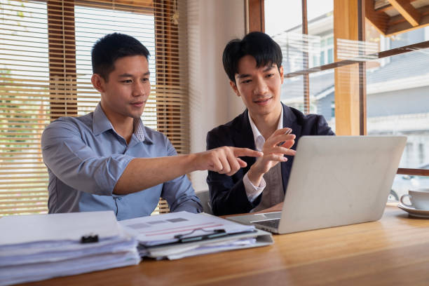 istock Two young entrepreneurs working together on new project in a modern workspace. 2117150820