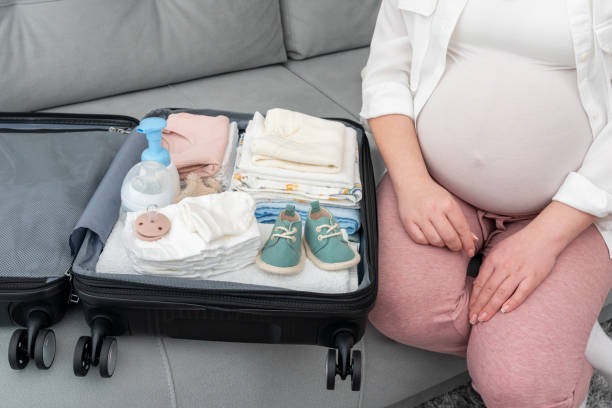 istock Suitcase with folded things for maternity hospital in pregnant woman's suitcase 2117171838