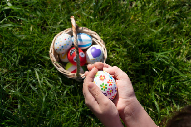 Colorful Easter eggs in little girls hand.Kids hunt for egg outdoors