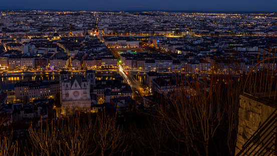 Lyon, France, march 19, 2024 :  Urban panorama at sunset of the city of Lyon with the city lights photographed from the Fourvière hill