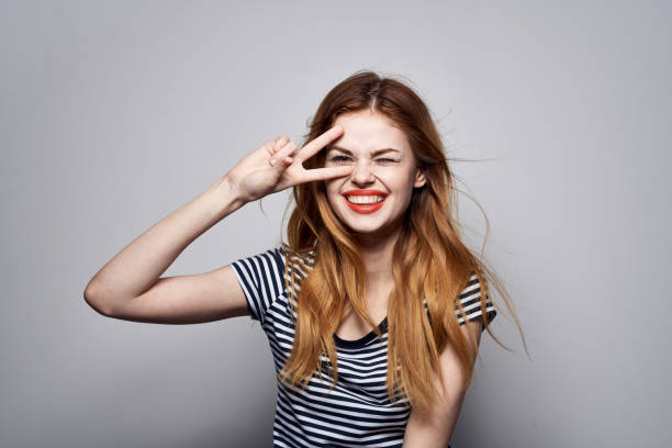 istock pretty woman holding hair makeup posing fun fashion expression model studio 2117226038