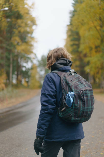 istock beautiful couple walking in the fall woods. 2117243218