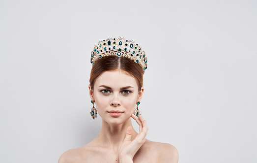 Beautiful woman beauty queen diadem earrings model makeup. High quality photo