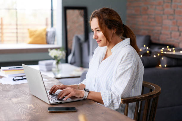 istock Young freelancer woman using laptop working online in the home office 2117247047
