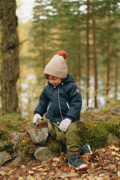 istock boy enjoying a walk in the fall woods 2117255648