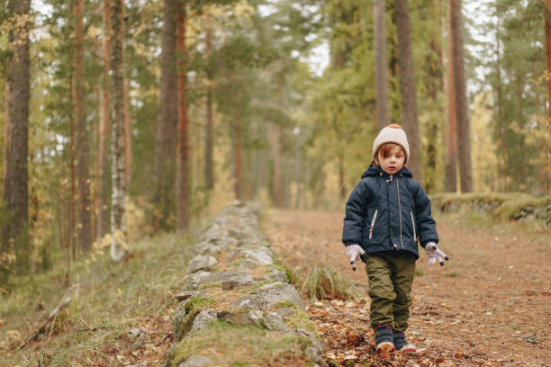 boy enjoying a walk in the fall woods