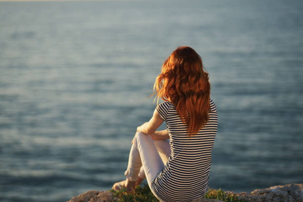 traveler by the sea at sunset back view. High quality photo