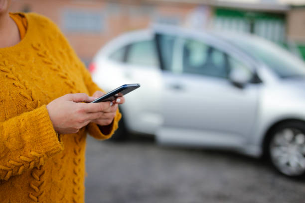 istock young woman Hispanic crashed with his car using his cell phone. road safety concept 2117269560