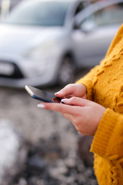 istock young woman Hispanic crashed with his car using his cell phone. road safety concept 2117269563