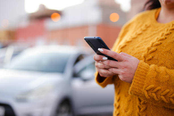 istock young woman Hispanic crashed with his car using his cell phone. road safety concept 2117269654
