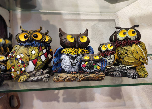 istock Decorative multicolored owl figurines on the shop window 2117327291