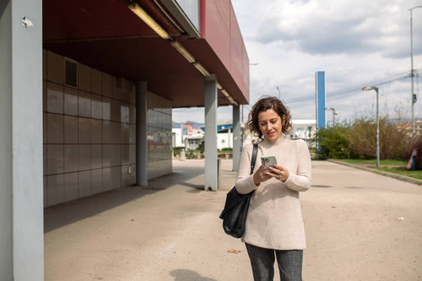 istock Woman using a smartphone outdoors 2117340783