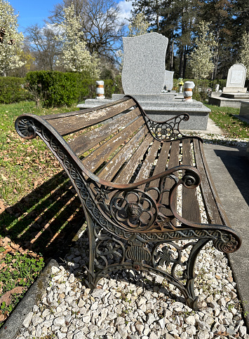 Old ornate metal bench in the public cemetery