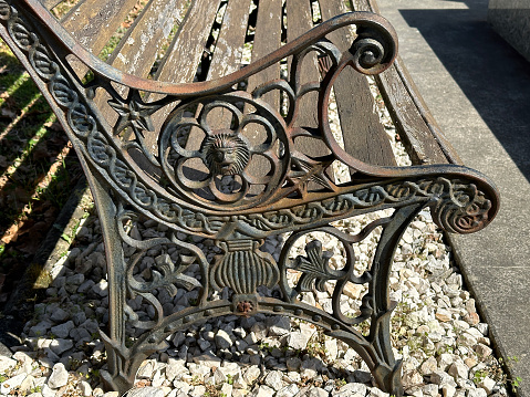 Old ornate metal bench in the public cemetery