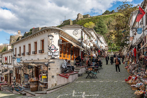 Gjirokaster, Albania. 15 March 2024. People on old town Gjirokaster streets with souvenir shops.