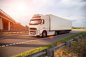 a-white-modern-truck-with-an-isothermal-refrigerated-semi-trailer-transports-perishable.jpg?b=1&s=170x170&k=20&c=tpmoQMp7rr5XIIm2Tan2UqUT7BpDRX5eV2FKgKEpQjk=