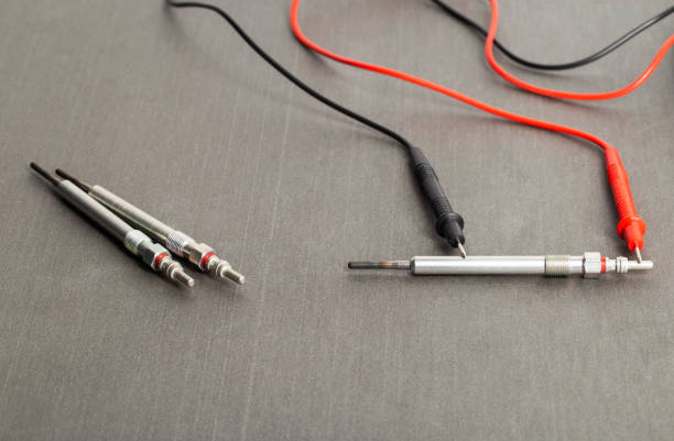 istock Checking the serviceability of the glow plug with a multimeter. Glow plug voltage resistance. Modern heating element, close-up 2117374502