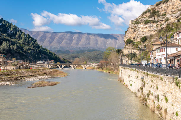 Berat, Albania. 15 March 2024. People on the road along River Osum in Berat, Albania.