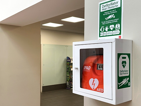 Strensham, Worcestershire, UK - 15 March 2024: Heart start defibrillator on the wall of a motorway service station for use in an emergency