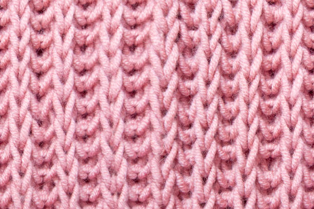 istock pink beautiful knitted braid pattern of light natural wool yarn, seamless knitted texture, concept warm things for cold weather, knitting hobby, needlework, fashion clothes 2117402357
