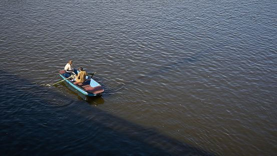 Prague, Czech Republic – October 06, 2023: Couple in a rowing boat on the Vltava River near Prague with text space on the right side