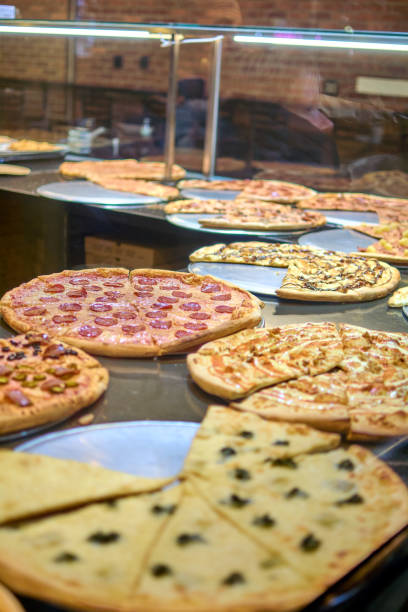 istock Variety of fresh pizzas on display 2117421788