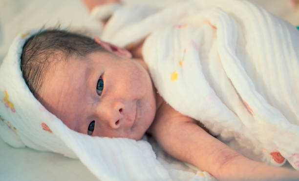 istock Newborn Baby in White Blanket 2117425043