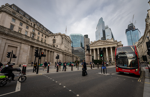 London, UK: Bank Junction in the City of London. Bank of England left, Royal Exchange center and skyscrapers behind.