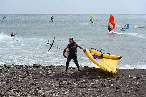 Puerto del Rosario, Fuerteventura, Spain, February 24, 2024 - Kitesurfers and windsurfers at Barlovento beach in Jandía, Fuerteventura, Canary Islands.