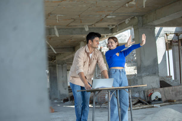istock Young couple planning their dream house at site 2117429845