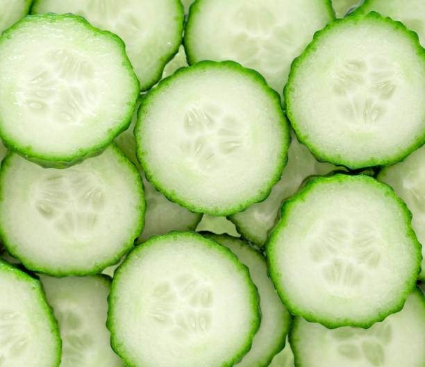 istock Fresh green cucumber slices background. Top view. 2117450381