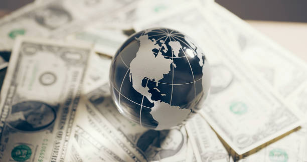 istock Glass globe and money 2117463752