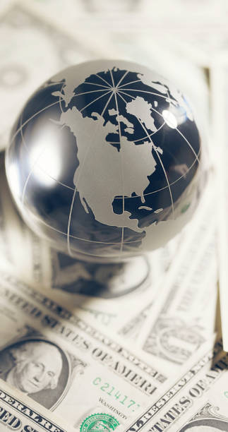 istock Glass globe and money 2117464272