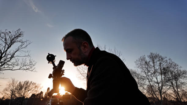 istock Amateur astronomer observing Sun eclipse and Sun with a telescope and special solar filter. 2117502758