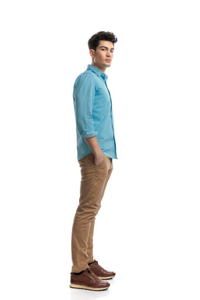 istock handsome casual man waiting in line while holding pockets 2117538905