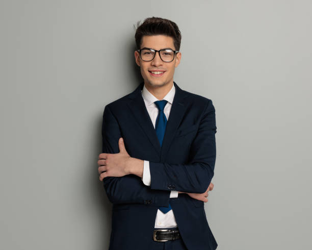 istock confident businessman wearing glasses with arms folded 2117543728