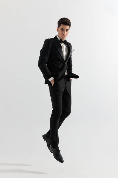 istock attractive businessman with hands in pockets in the air 2117547512