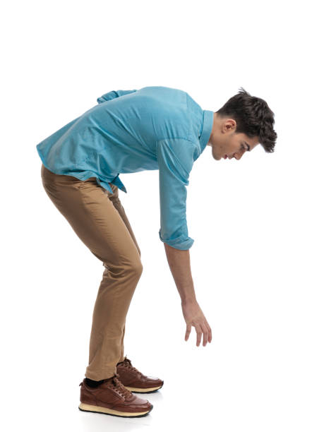 istock side view of casual man picking something up 2117550824