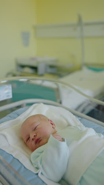 MS Newborn Innocence: Tiny Hands of a Newborn Resting in Hospital Crib at Maternity Ward