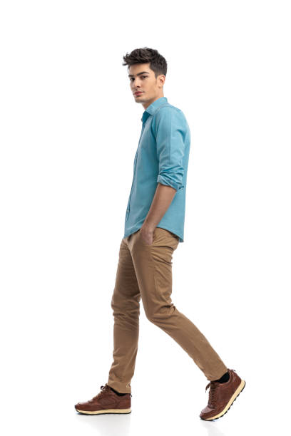 istock sexy casual man walking to side with hands in pockets 2117551936