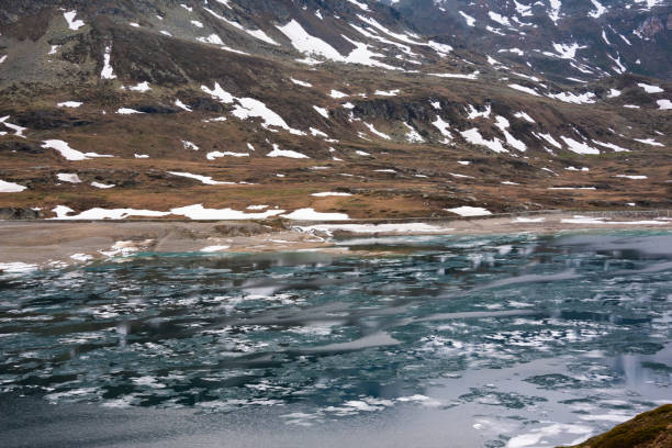 Mountain lake with ice and snow in Switzerland in spring
