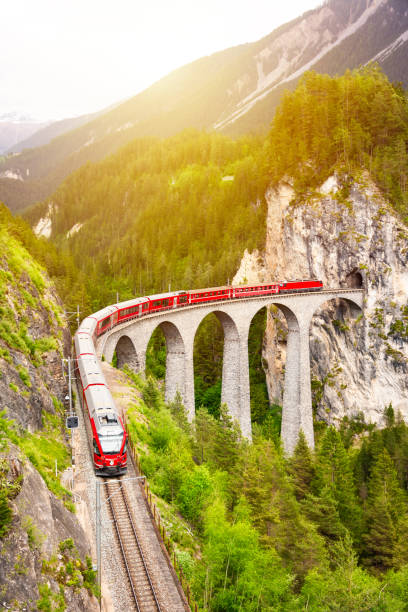 istock Swiss red train on viaduct in mountain, scenic ride 2117555245