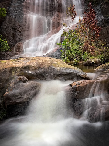 Vertical image with long exposure of waterfall during the day