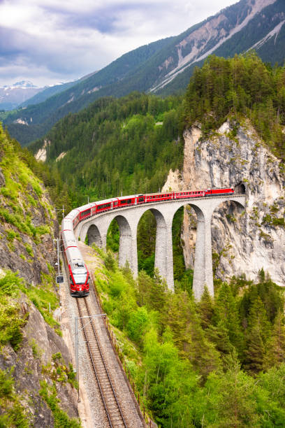 istock Swiss red train on viaduct in mountain, scenic ride 2117559518