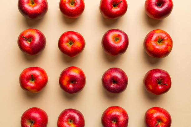 istock Many red apples on colored background, top view. Autumn pattern with fresh apple above view 2117561665