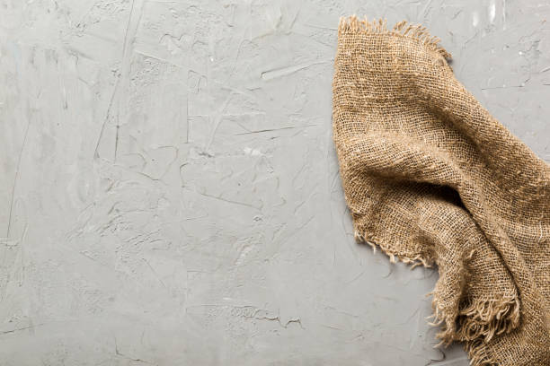 istock Old burlap fabric napkin, sackcloth on table background. top view with copy space 2117562304