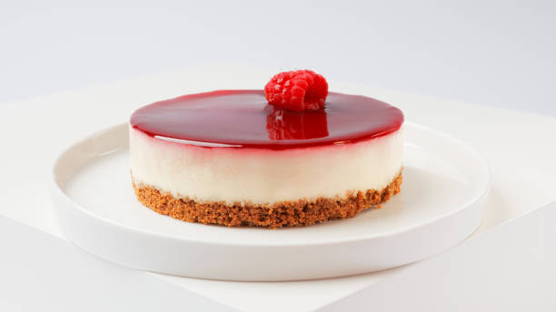 istock Cheesecake with raspberries on a white plate on a white background 2117584782
