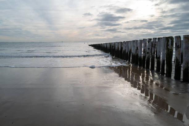 north sea coast, gloomy sunset behind rain clouds