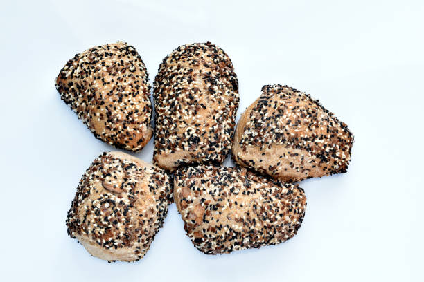 Homemade bread baked in the oven with cumin and flax grains lies on the table.